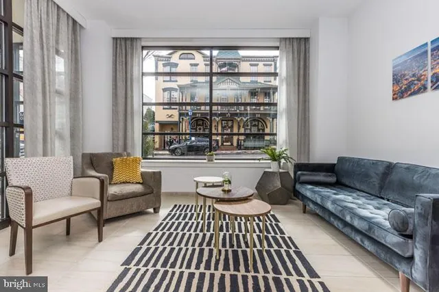 a living room filled with furniture and a book shelf