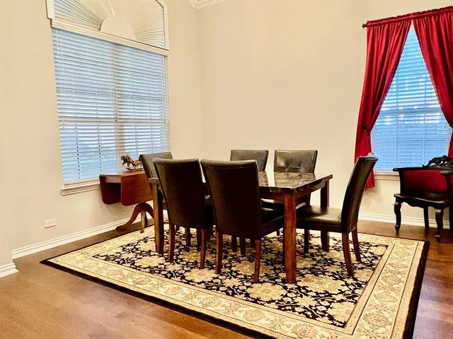 a view of a dining room with furniture and wooden floor