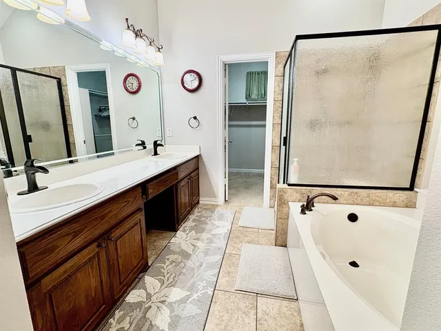 a bathroom with a double vanity sink mirror and shower