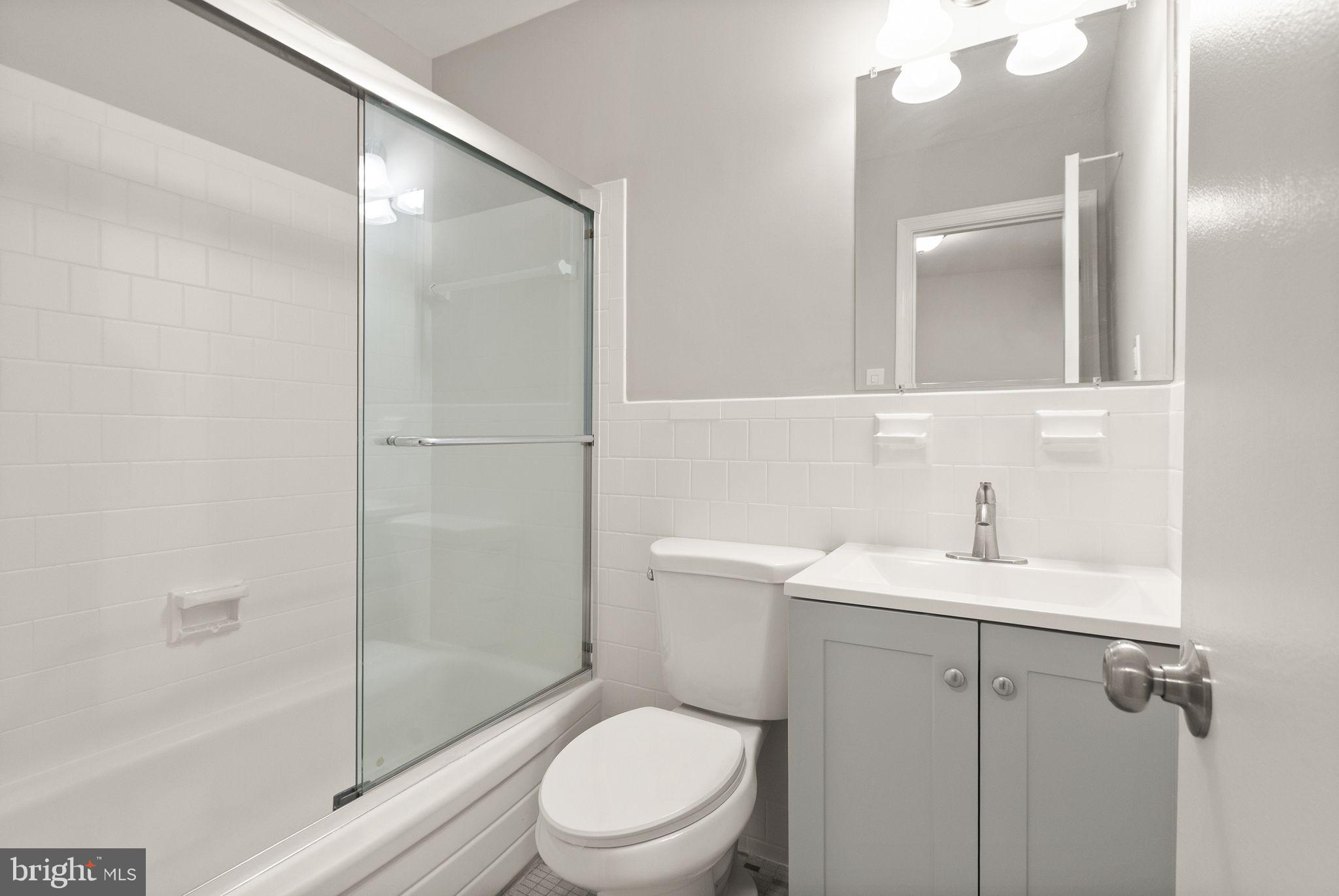 6611 Burlington Place Springfield, VA 22152 - Photo 22 of 41 a bathroom with a sink a toilet and shower