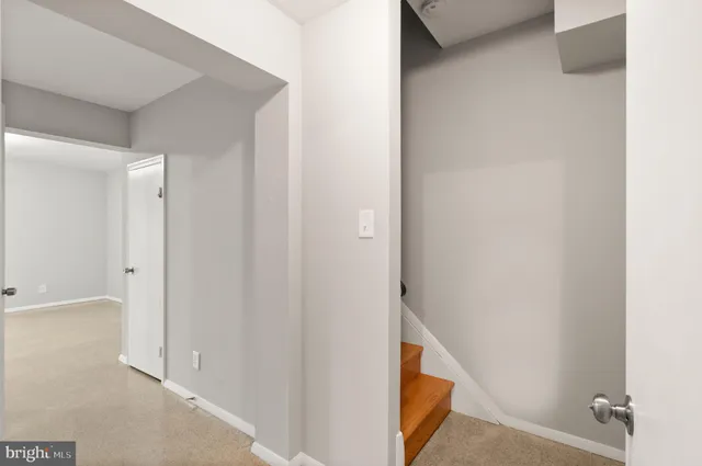 an empty room with wooden floor and sliding door