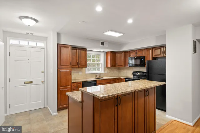a kitchen with a stove a refrigerator a sink and dishwasher