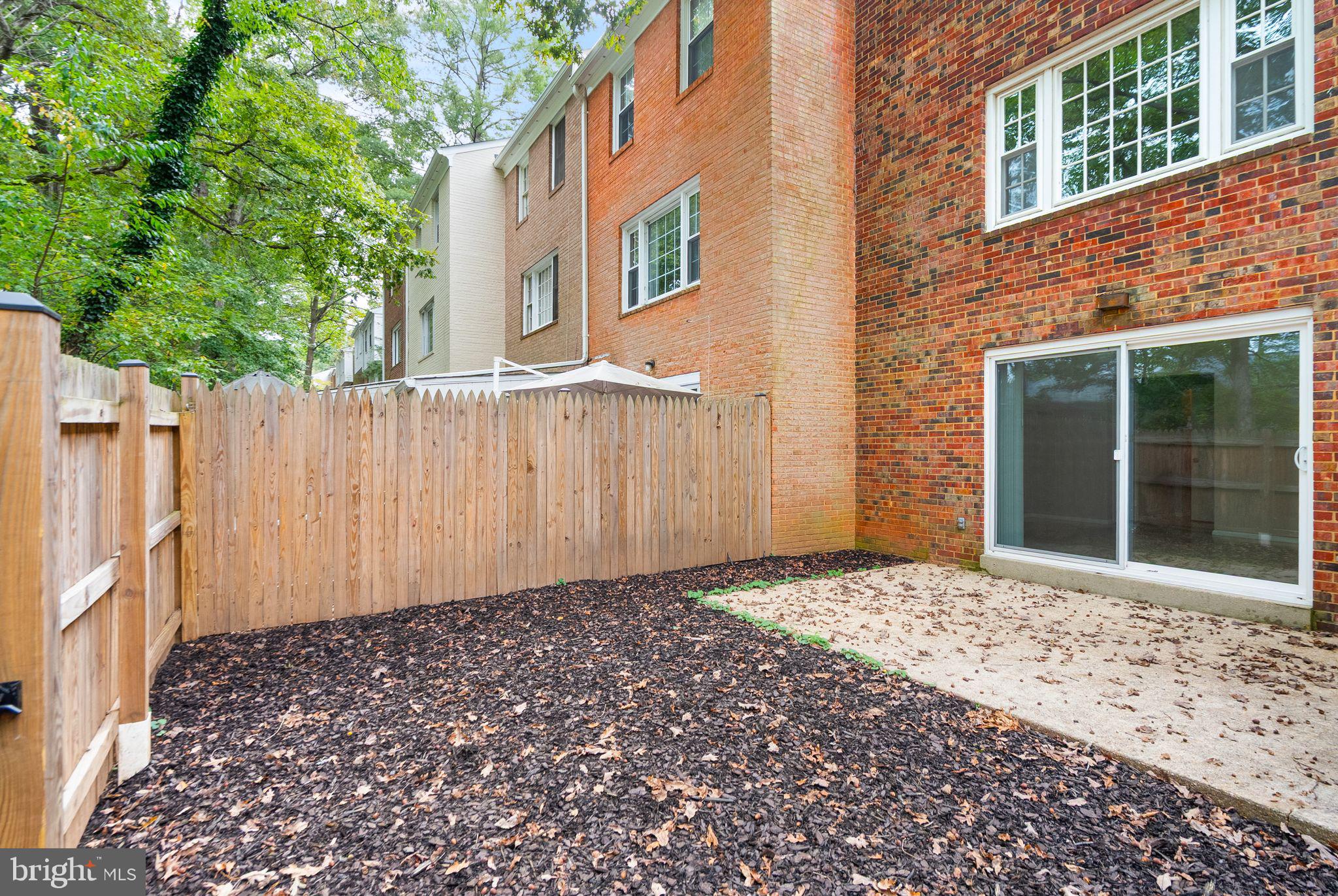 6611 Burlington Place Springfield, VA 22152 - Photo 32 of 41 a view of a house with a wooden fence