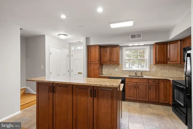a kitchen with lots of counter top space sink and a window