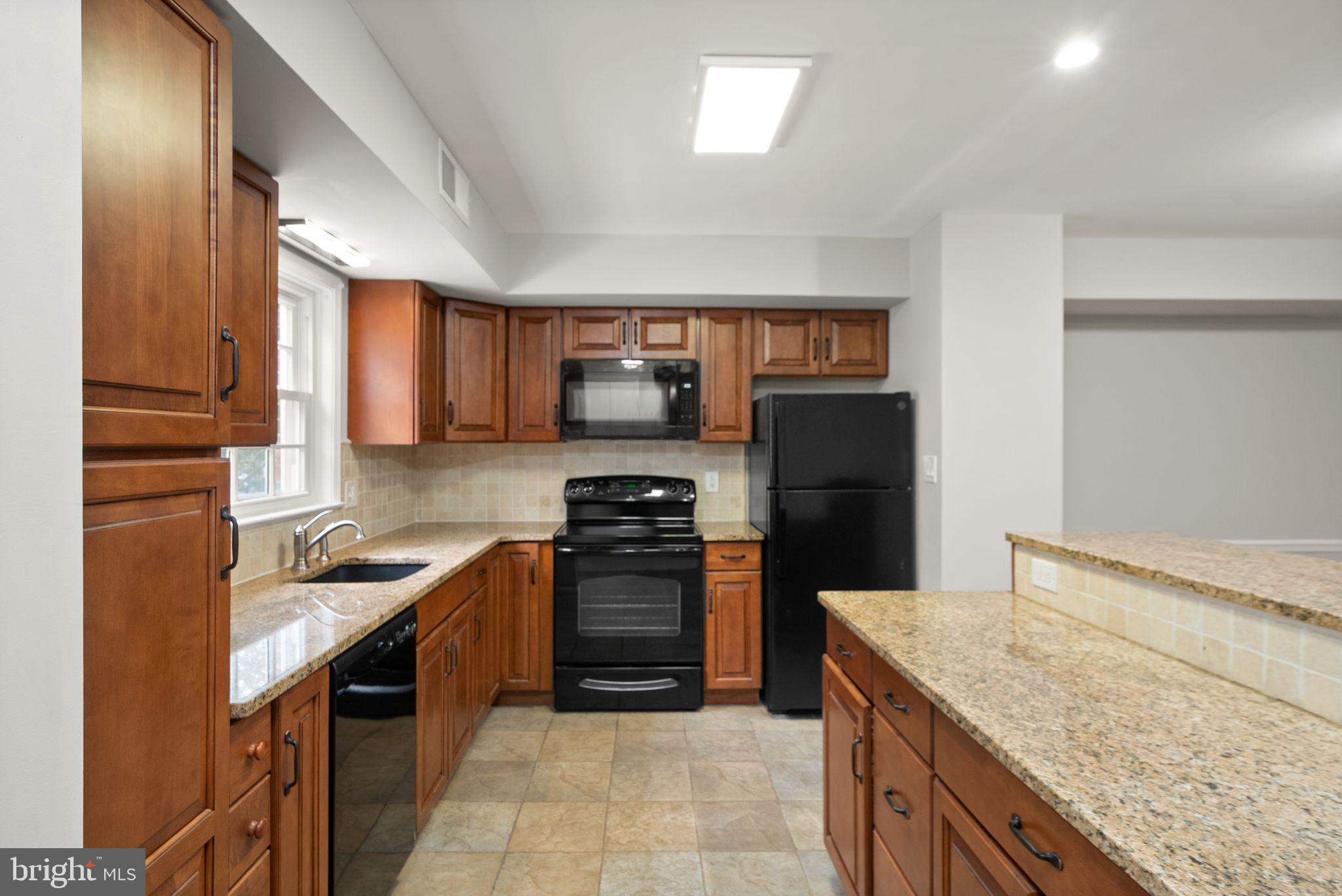 6611 Burlington Place Springfield, VA 22152 - Photo 5 of 41 a kitchen with a stove sink and refrigerator