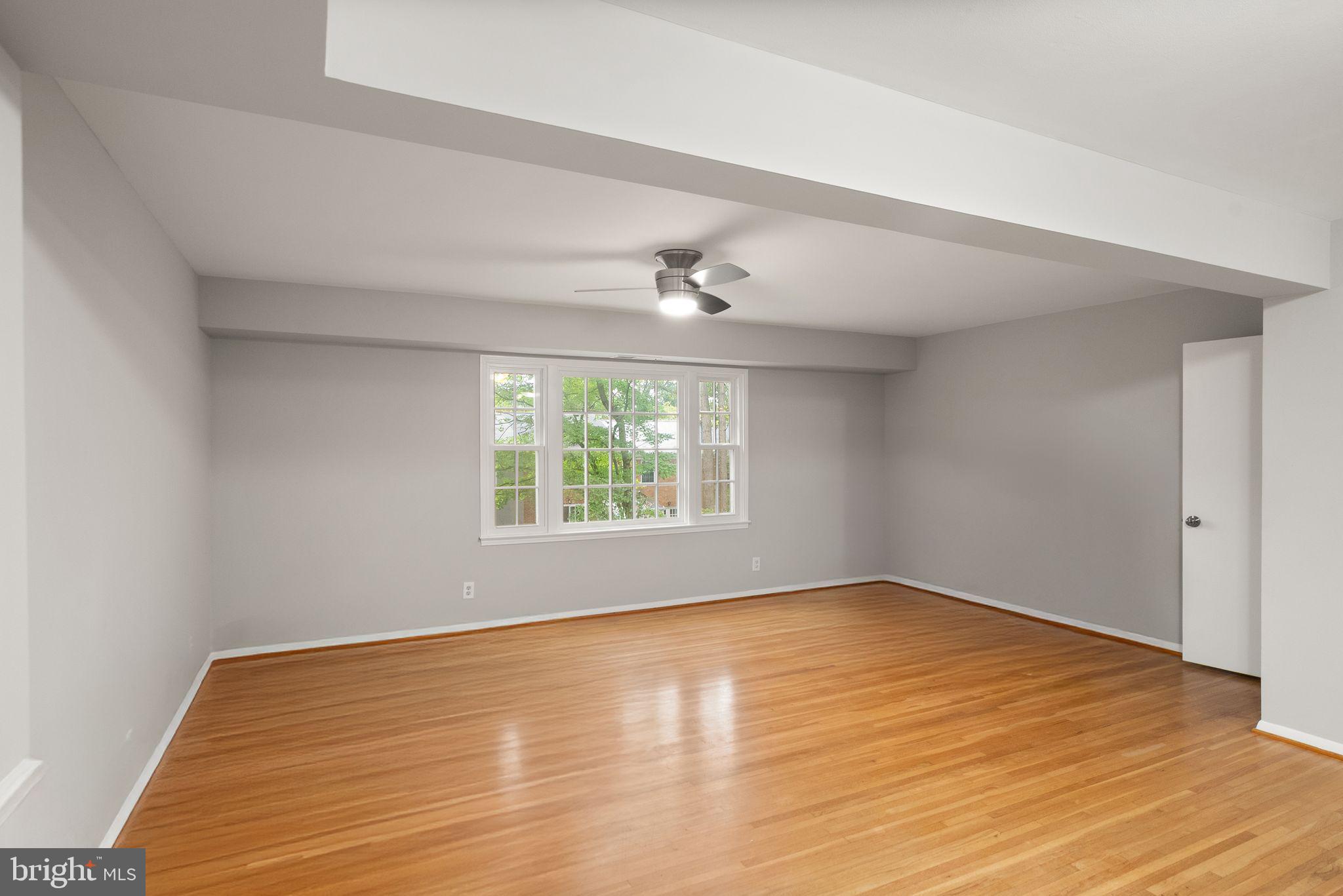 6611 Burlington Place Springfield, VA 22152 - Photo 8 of 41 a view of an empty room with wooden floor and a window