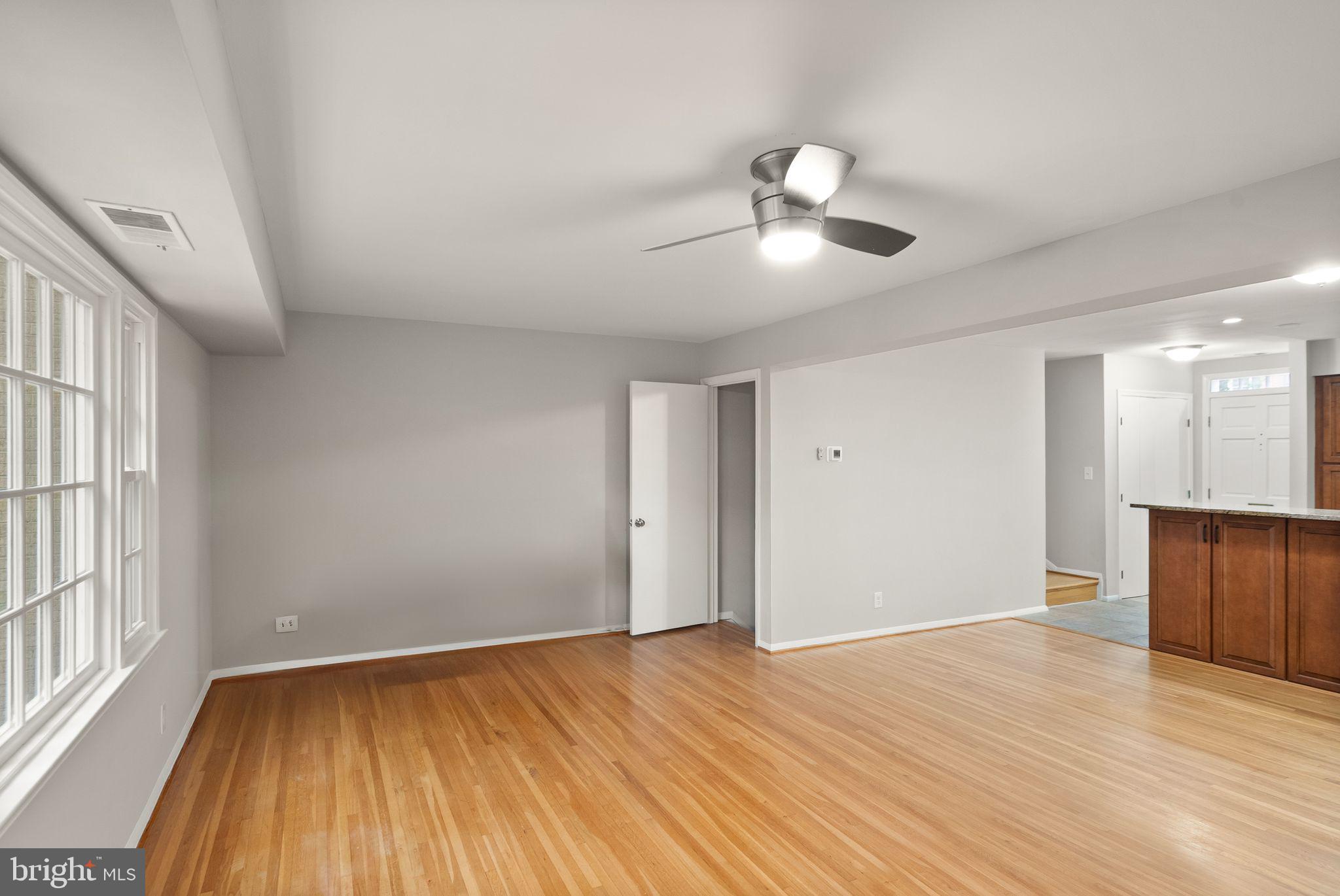 6611 Burlington Place Springfield, VA 22152 - Photo 9 of 41 a view of an empty room with wooden floor and a window