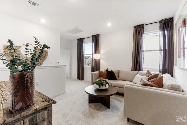 a living room with furniture and a potted plant