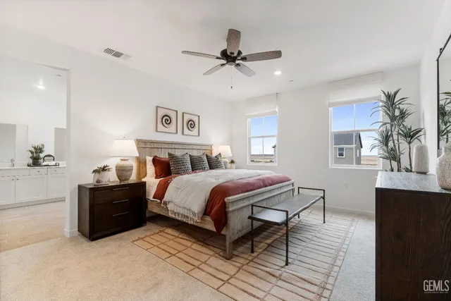 a spacious bedroom with a bed and window