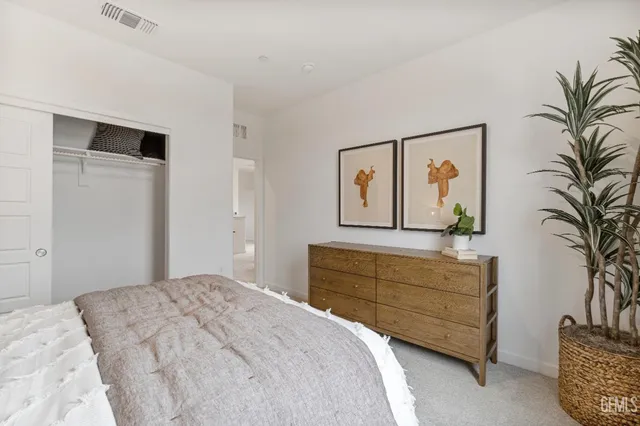 a bedroom with a bed and a painting on the wall