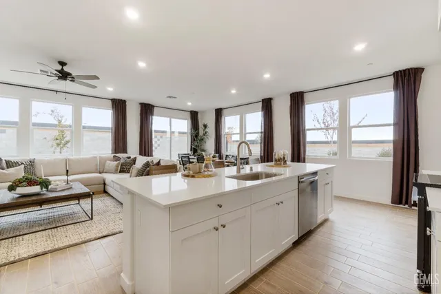 a large white kitchen with a large window