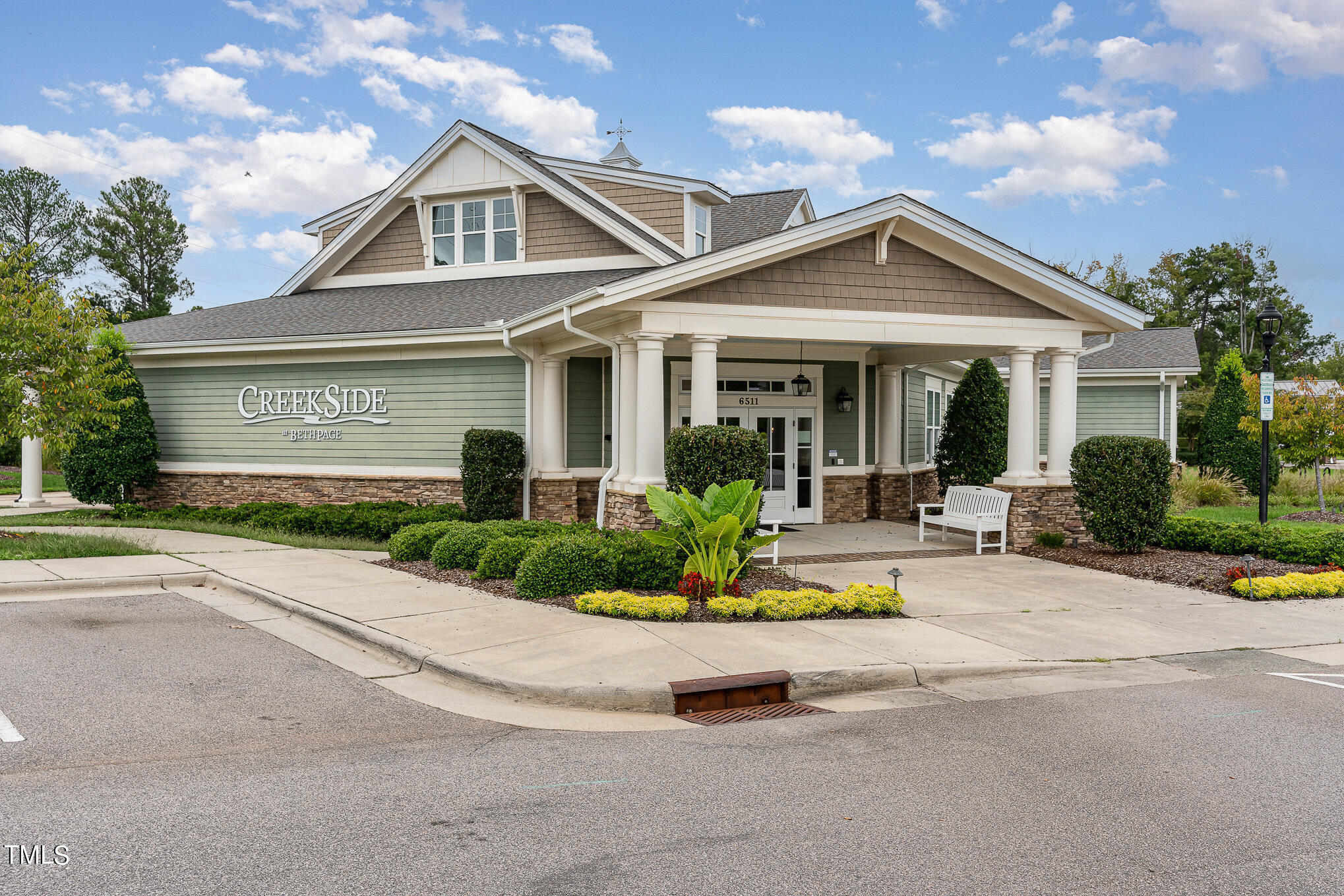 a front view of a house with a yard outdoor seating and garage