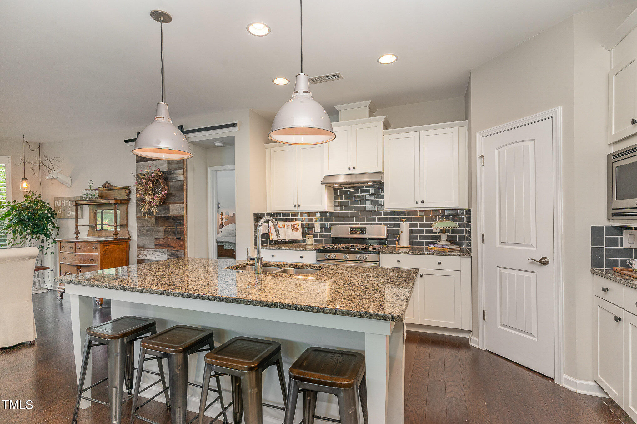 1308 Atticus Way Durham, NC 27703 - Photo 11 of 40 a kitchen with stainless steel appliances granite countertop a stove a sink and a refrigerator