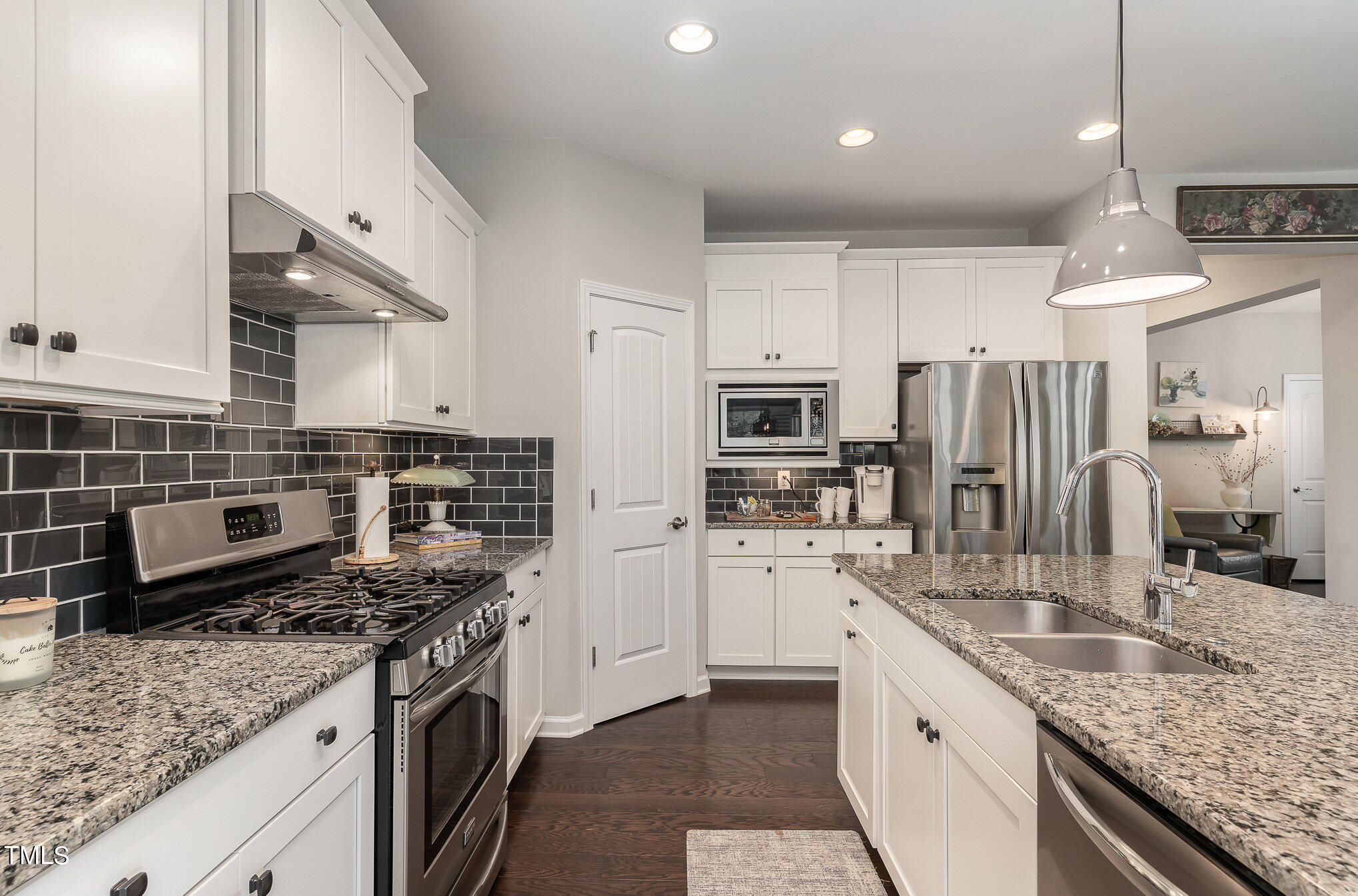 1308 Atticus Way Durham, NC 27703 - Photo 13 of 40 a kitchen with stainless steel appliances granite countertop a sink stove and refrigerator