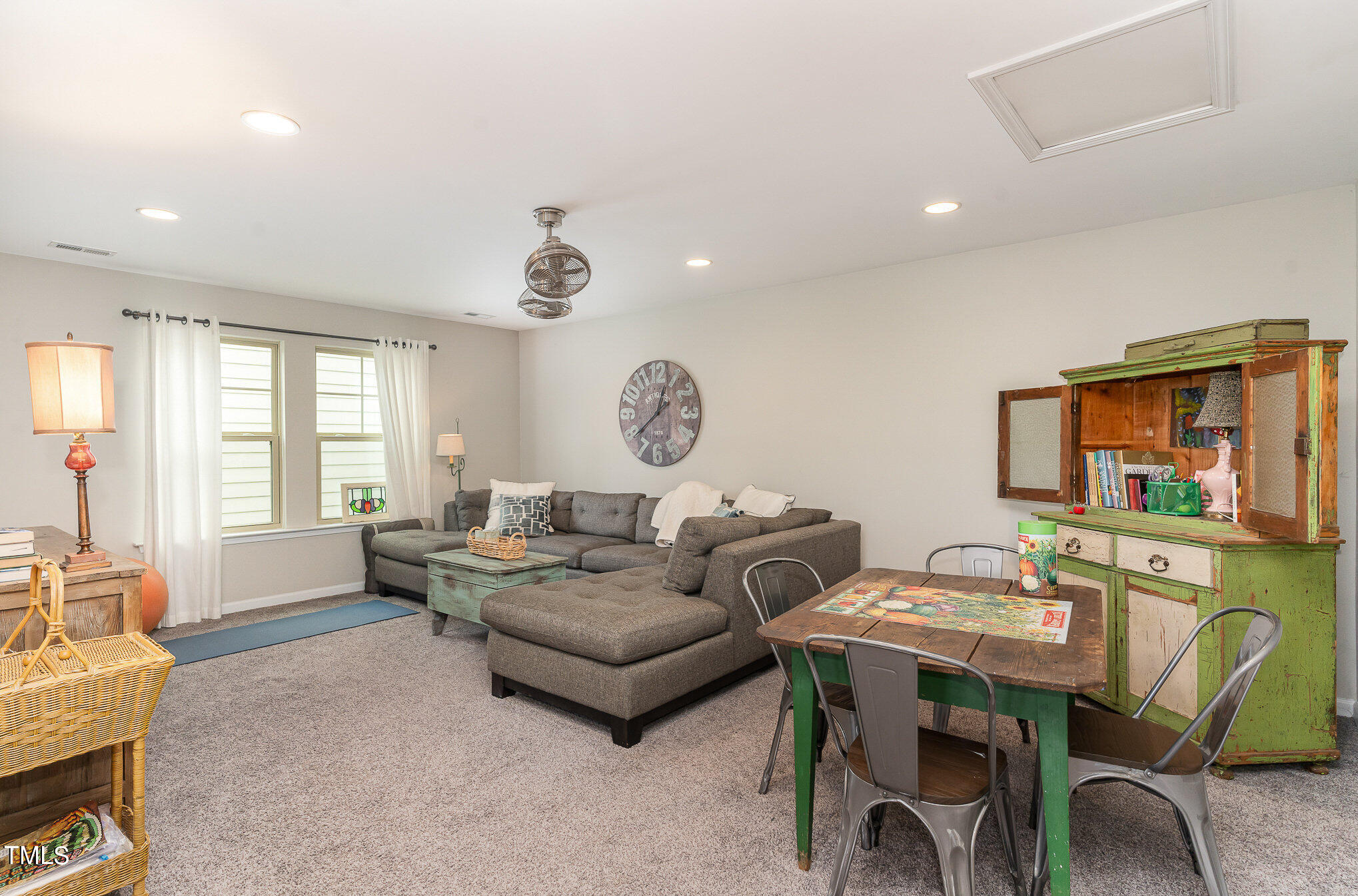 1308 Atticus Way Durham, NC 27703 - Photo 21 of 40 a living room with furniture a chandelier and a window