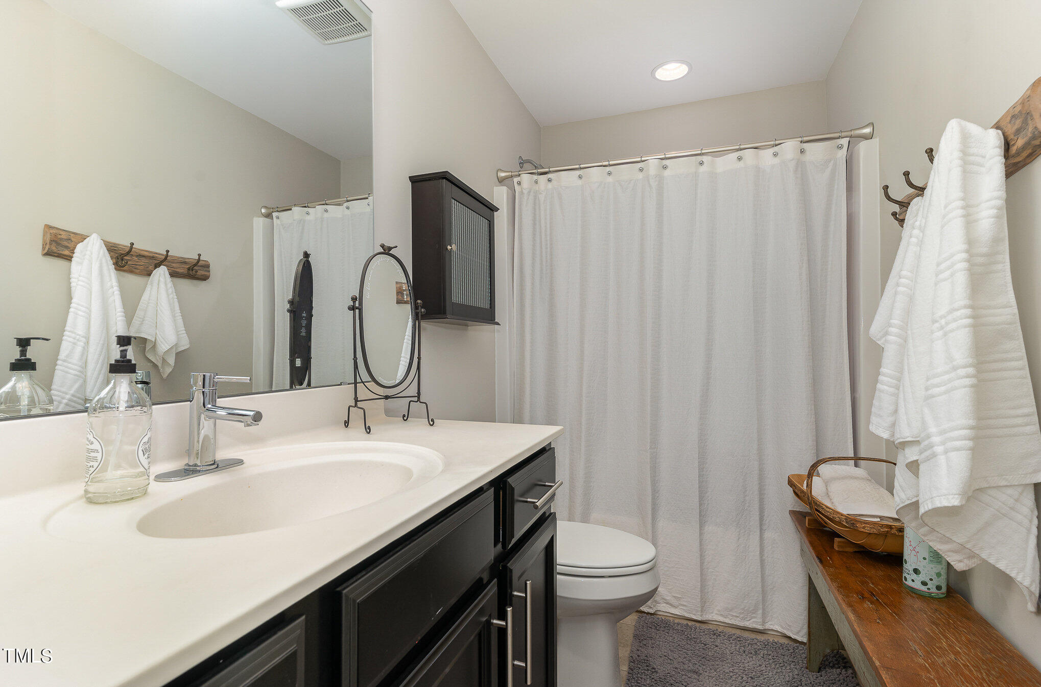 1308 Atticus Way Durham, NC 27703 - Photo 22 of 40 a bathroom with a double vanity sink and a mirror
