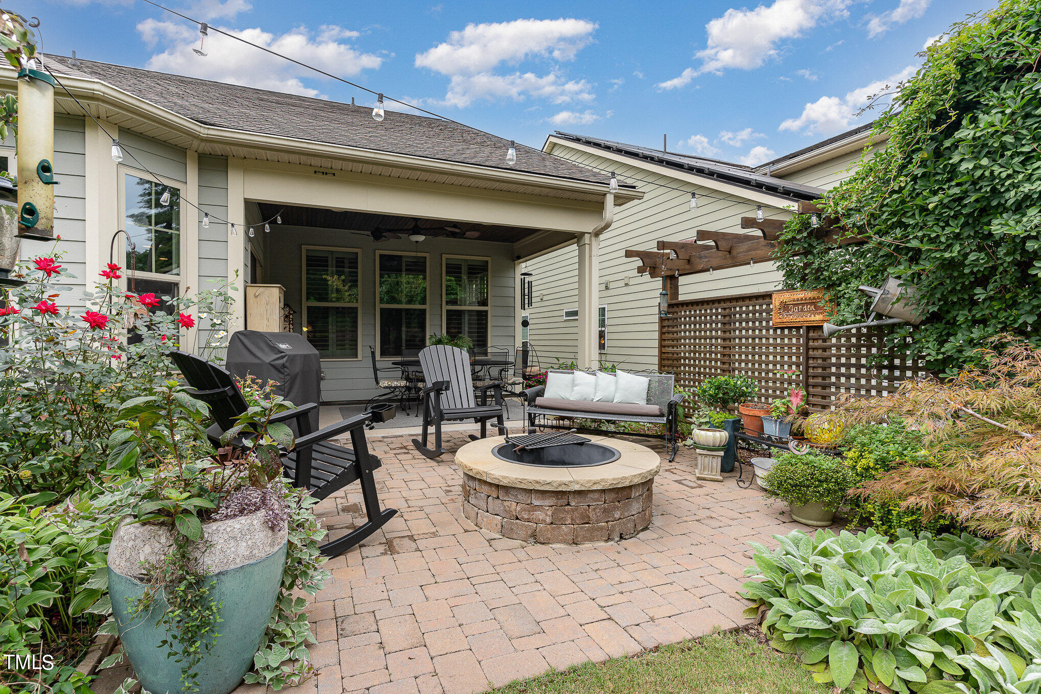 1308 Atticus Way Durham, NC 27703 - Photo 25 of 40 a view of a patio with dining table and chairs and potted plants