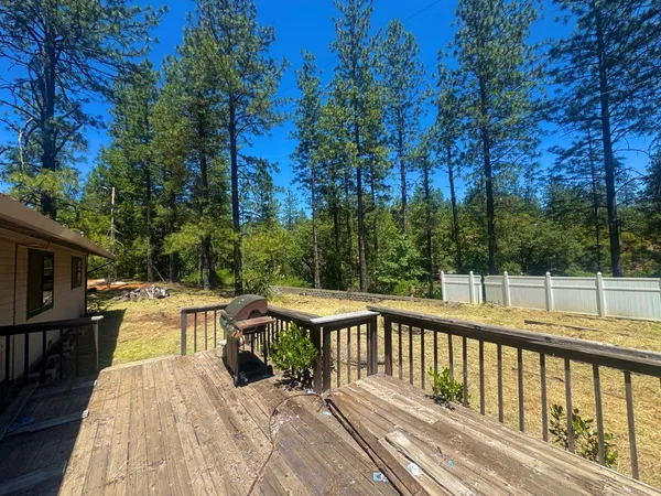 a view of balcony with wooden floor and outdoor seating