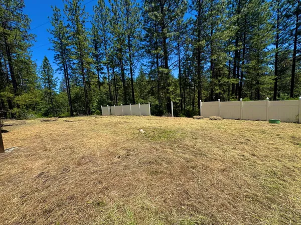 a view of white house with a yard