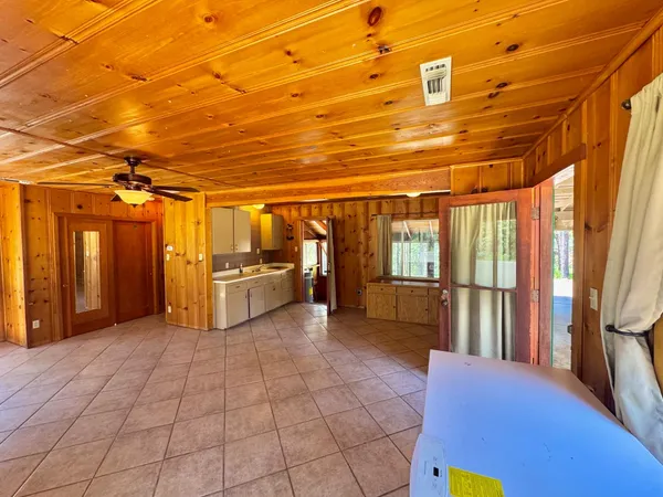 a view of a refrigerator with wooden cabinets