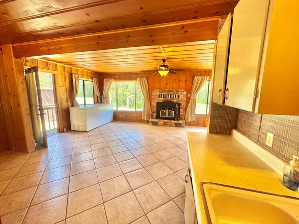 a view of kitchen with a sink and a refrigerator