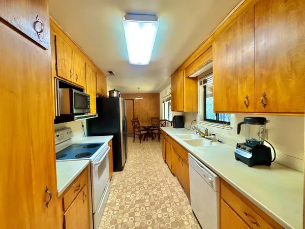 a large kitchen with a large counter top appliances and cabinets