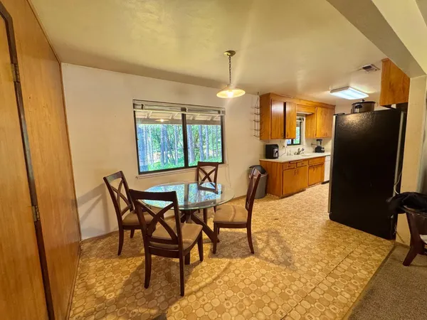 a dining room with furniture and window