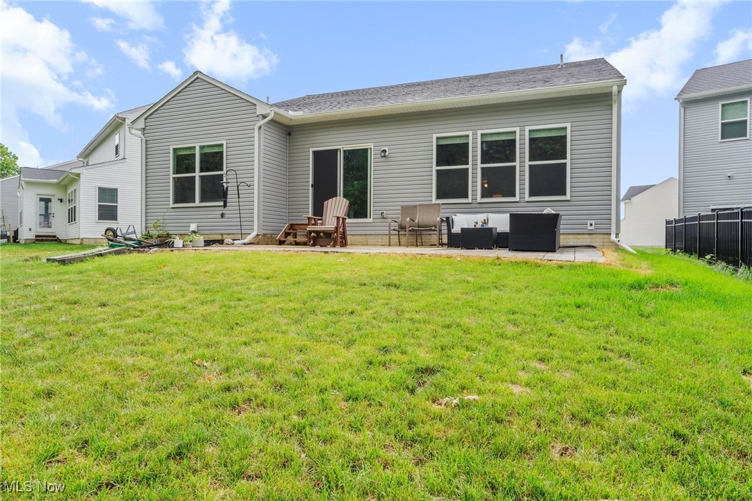 6824 Hatching Way North Ridgeville, OH 44039 - Photo 35 of 42 Back of property featuring a lawn and a patio area