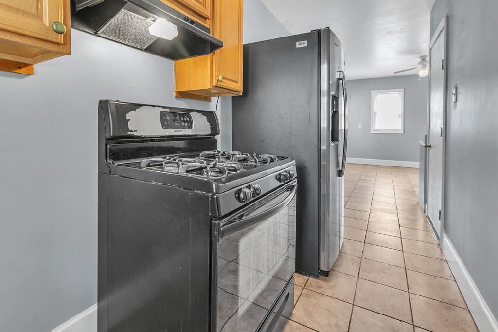89 Sylvester Street Springfield, MA 01109 - Photo 8 of 41 a kitchen with a stove top oven and cabinets