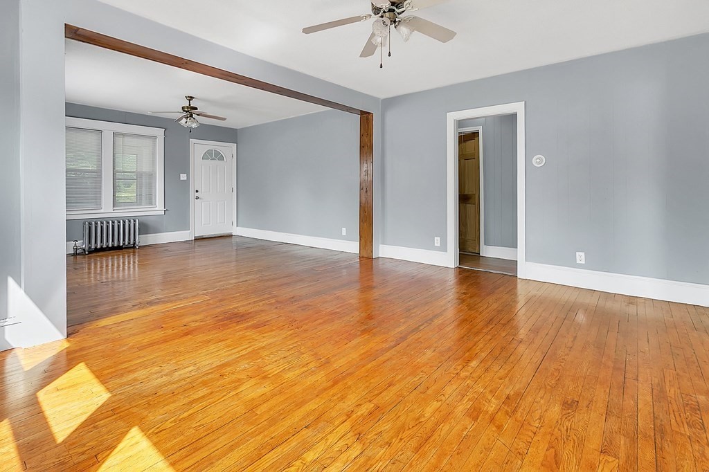 89 Sylvester Street Springfield, MA 01109 - Photo 9 of 41 a view of an empty room with wooden floor and a ceiling fan