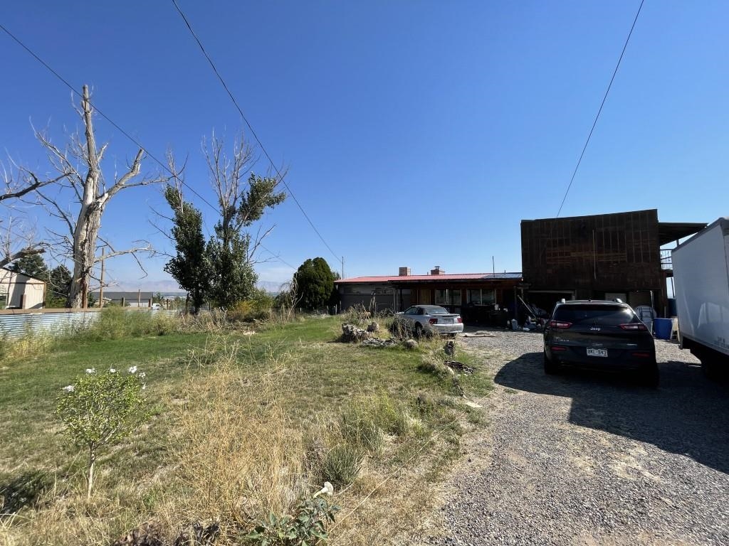 a view of a backyard with plants and a patio
