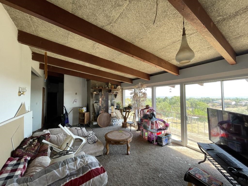 117 Easter Hill Drive Grand Junction, CO 81507 - Photo 3 of 21 a living room with furniture a flat screen tv and a large window