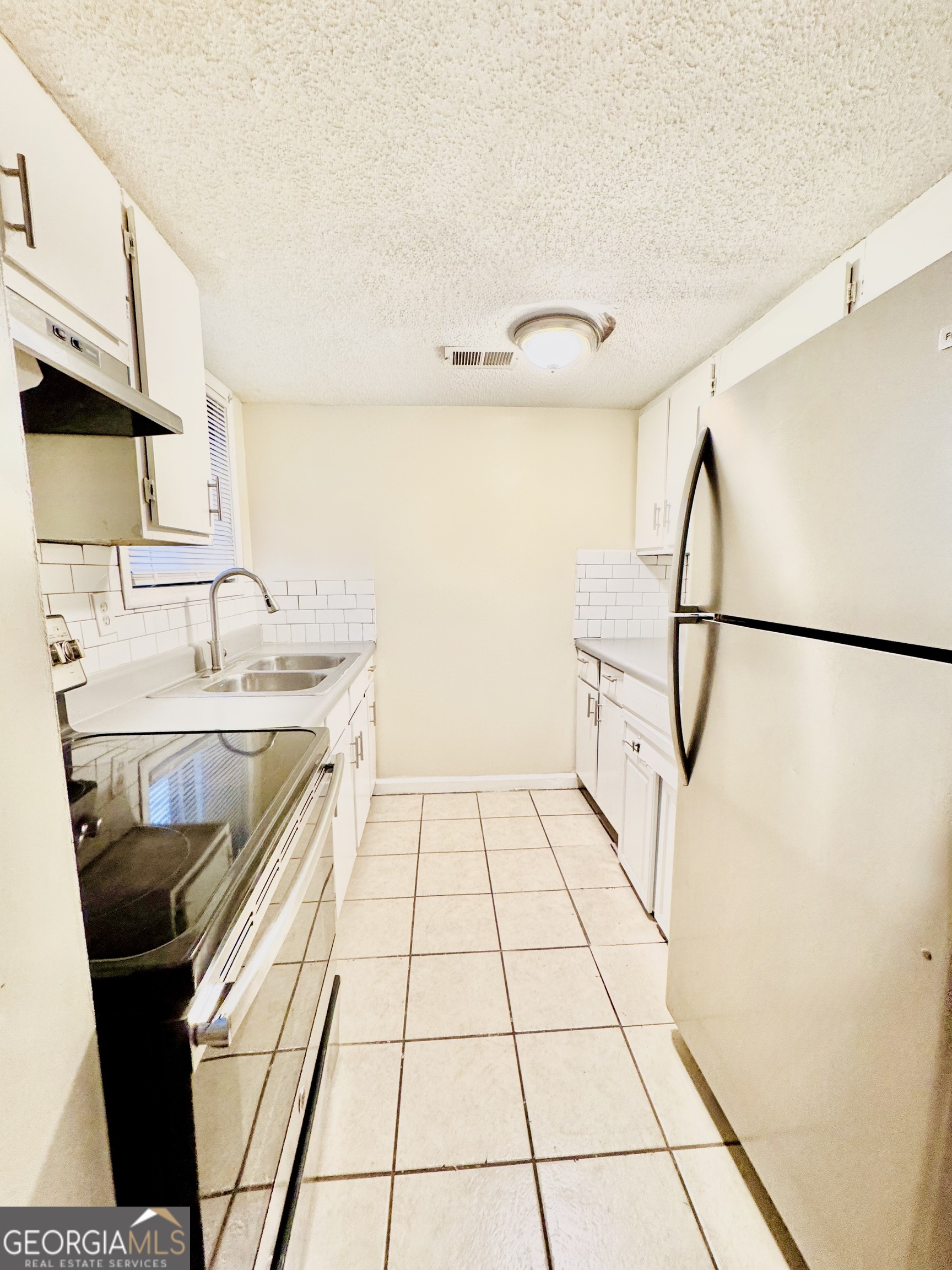 4755 Yates Road, Unit 4A College Park, GA 30337 - Photo 2 of 15 a kitchen with a sink a stove and a refrigerator