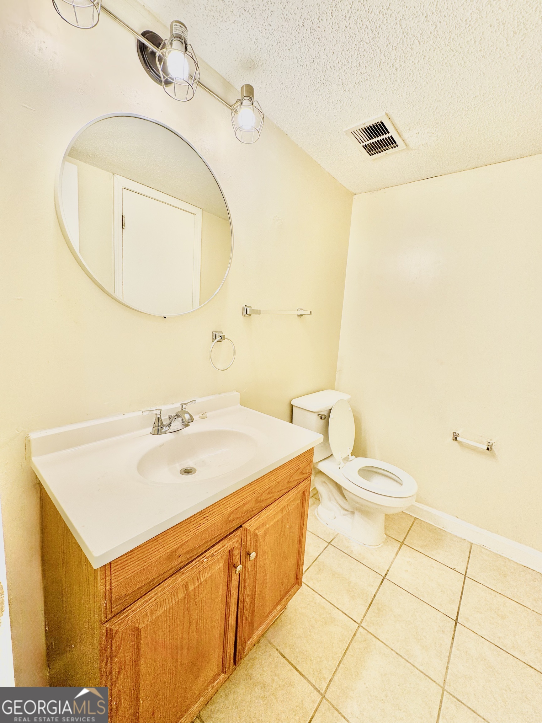 4755 Yates Road, Unit 4A College Park, GA 30337 - Photo 6 of 15 a bathroom with a sink a toilet and a mirror