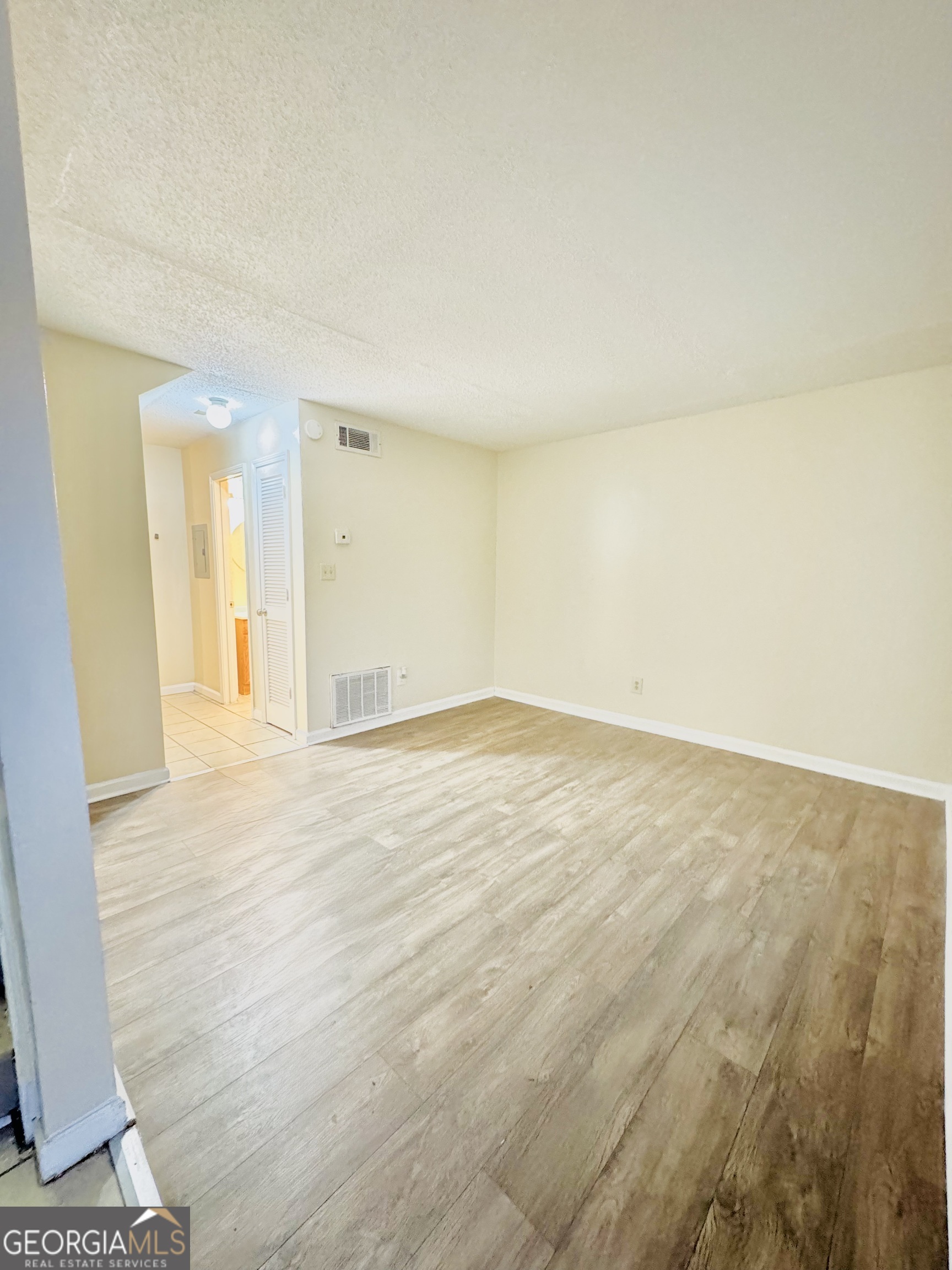 4755 Yates Road, Unit 4A College Park, GA 30337 - Photo 8 of 15 an empty room with wooden floor and bathroom view