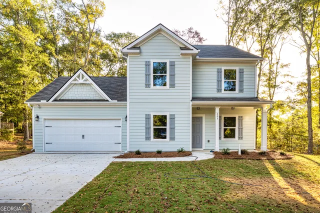 a front view of a house with a yard and garage
