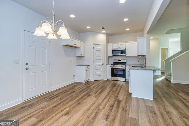 a view of a kitchen with microwave and cabinets