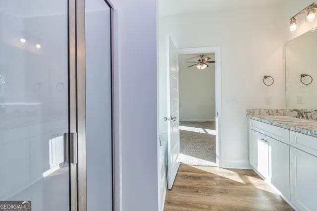 a view of a hallway with closet and wooden floor