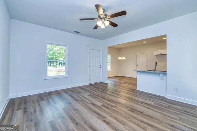 wooden floor in an empty room with a window