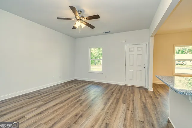 wooden floor in an empty room with a window