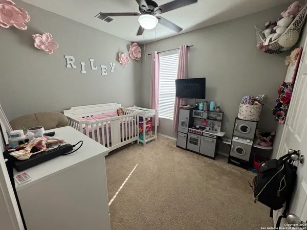 a bedroom with bed and a tv