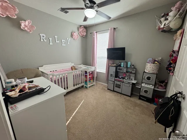 a bedroom with bed and a tv