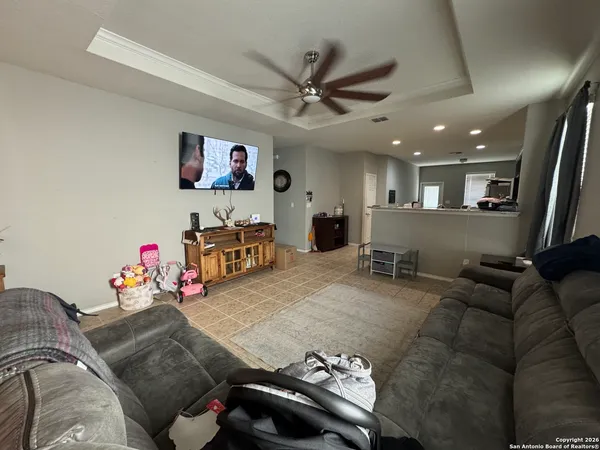 a living room with furniture and a flat screen tv