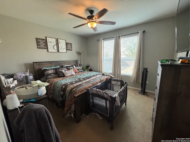 a bedroom with bed and a chandelier