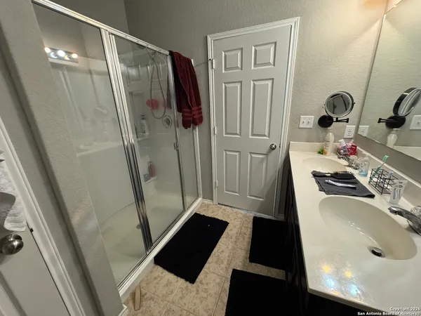 a bathroom with a sink a toilet a shower and vanity