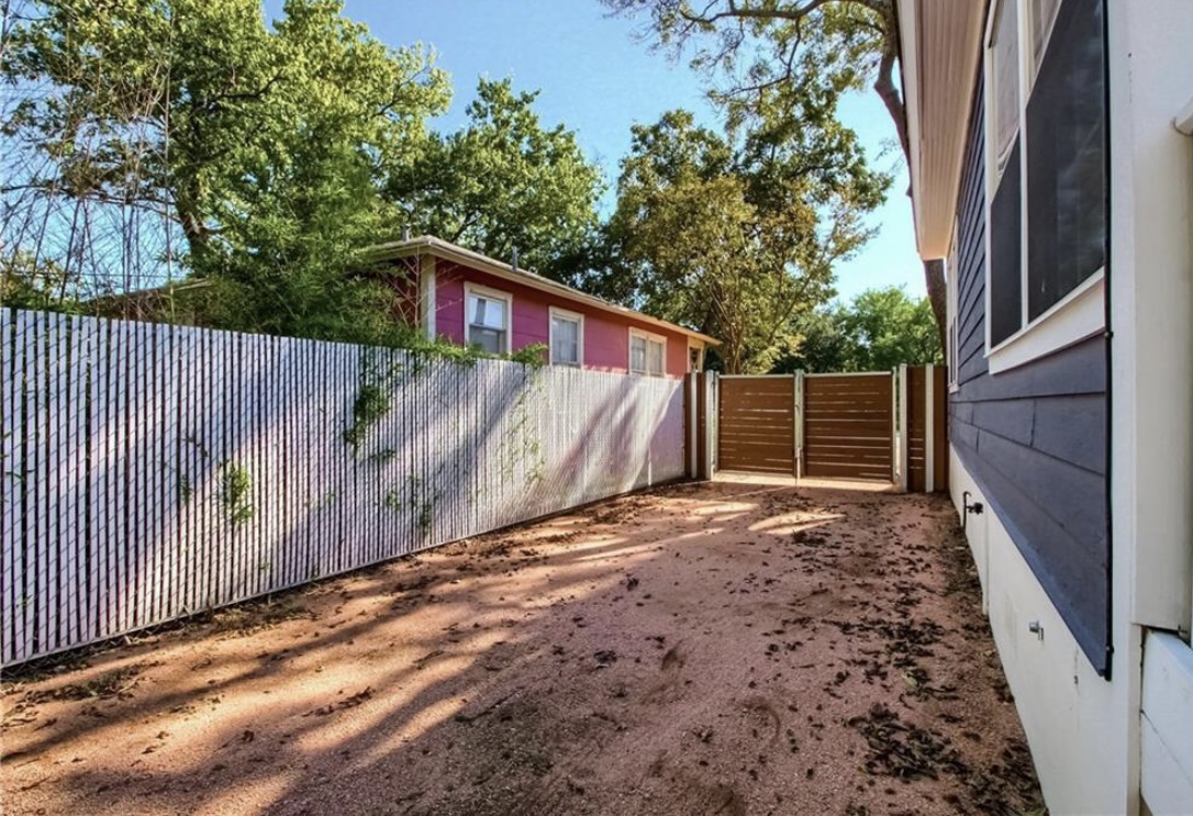 702 West N Loop Boulevard Austin, TX 78751 - Photo 15 of 23 Secure yard space with privacy fencing and robust gates provides ample room for outdoor activities.