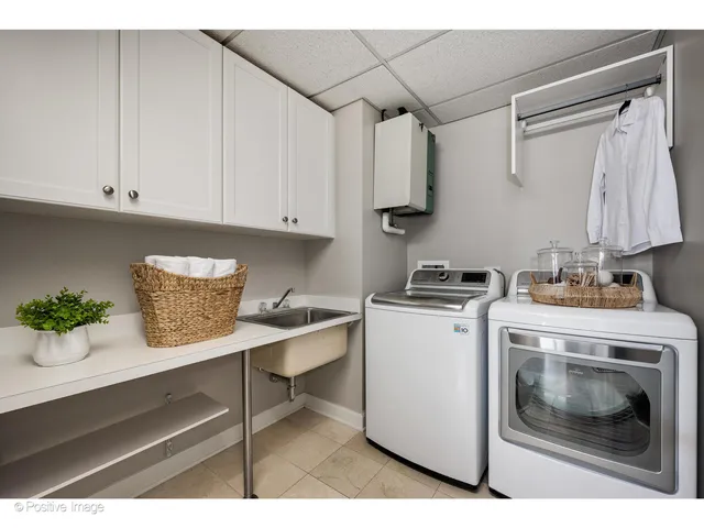 a utility room with cabinets washer and dryer