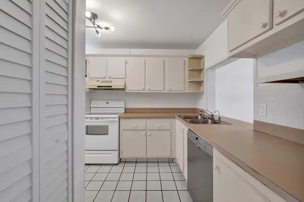 a view of empty room with wooden floor and window