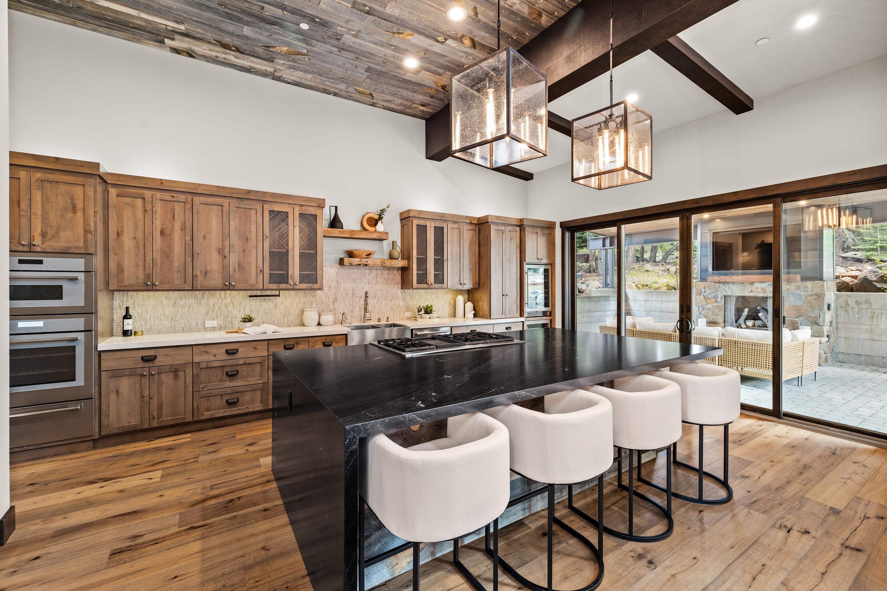 9355 Nine Bark Road Truckee, CA 96161 - Photo 8 of 21 a kitchen with granite countertop a sink cabinets and wooden floor
