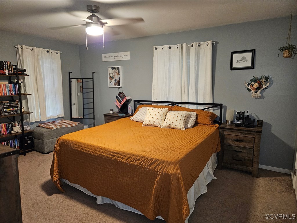 7106 Full Rack Drive Midlothian, VA 23112 - Photo 15 of 26 a bedroom with a bed and a chandelier